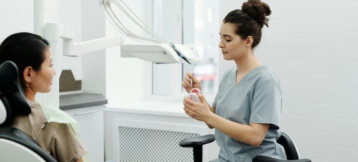 dentist preparing to clean patient's teeth